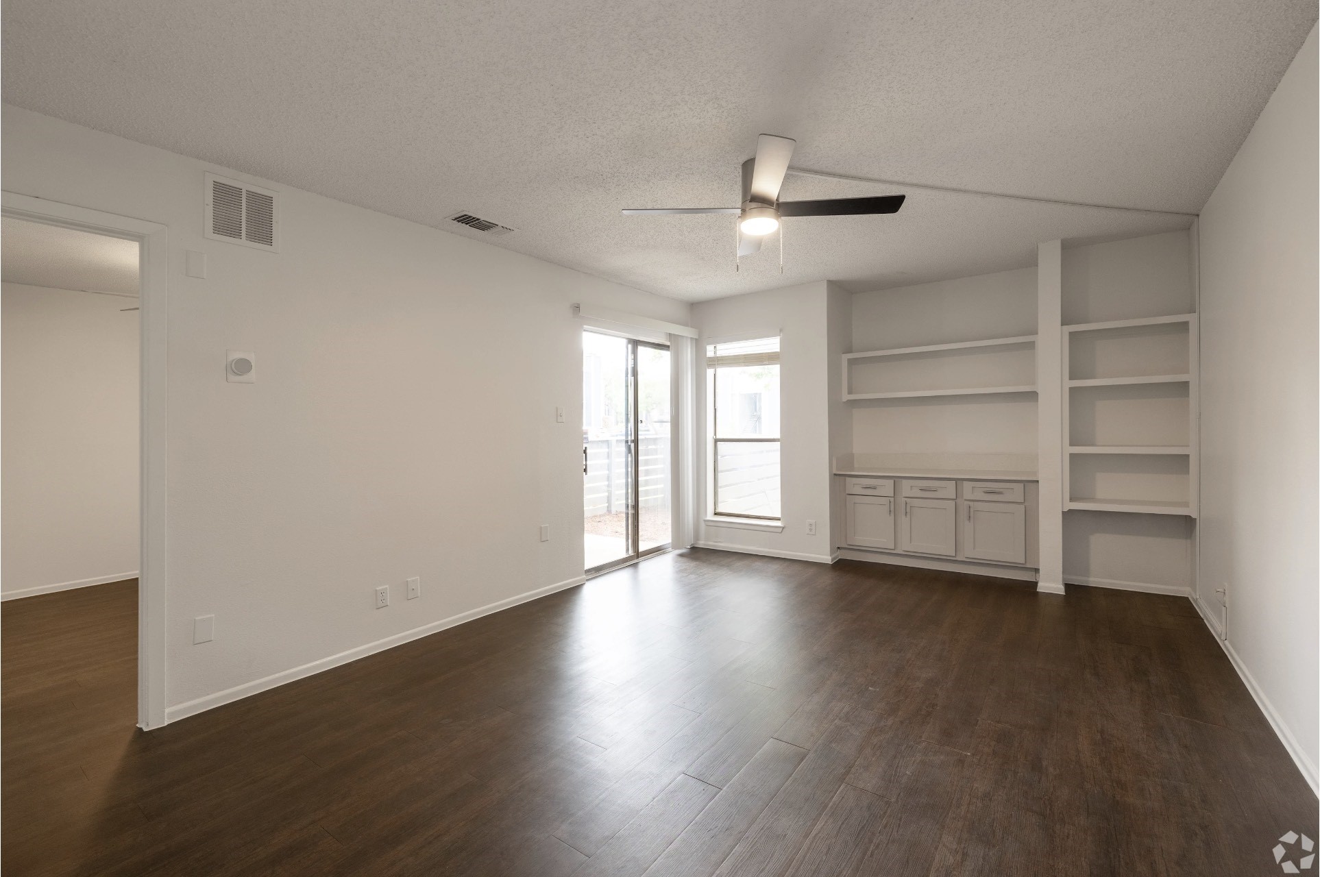 2170 Thousand Oaks Drive, Unit 536T San Antonio, TX 78232 - Photo 22 of 36 a view of an empty room with a window and wooden floor