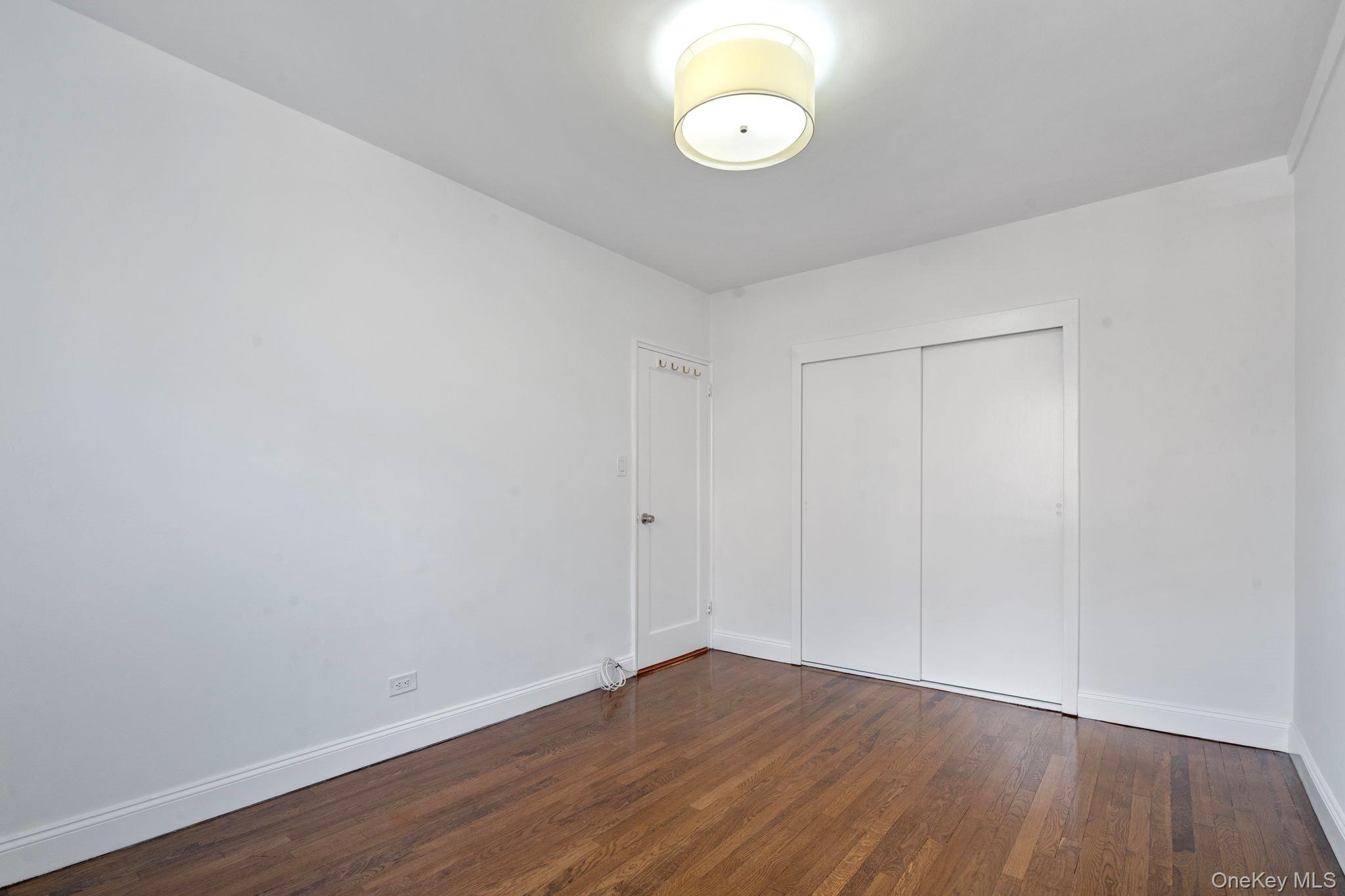32-40 89th Street, Unit C409 Queens, NY 11369 - Photo 14 of 32 a view of a room with wooden floor