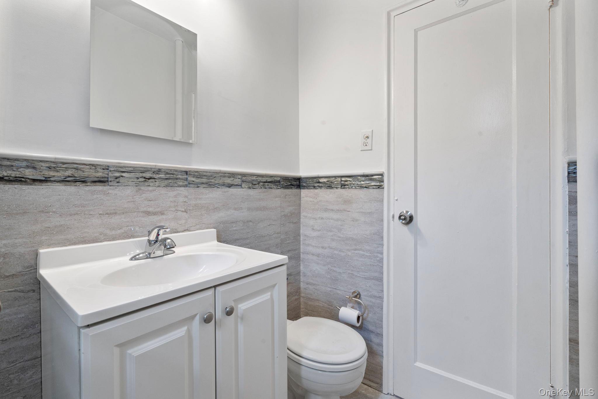 32-40 89th Street, Unit C409 Queens, NY 11369 - Photo 16 of 32 a bathroom with a sink toilet and vanity