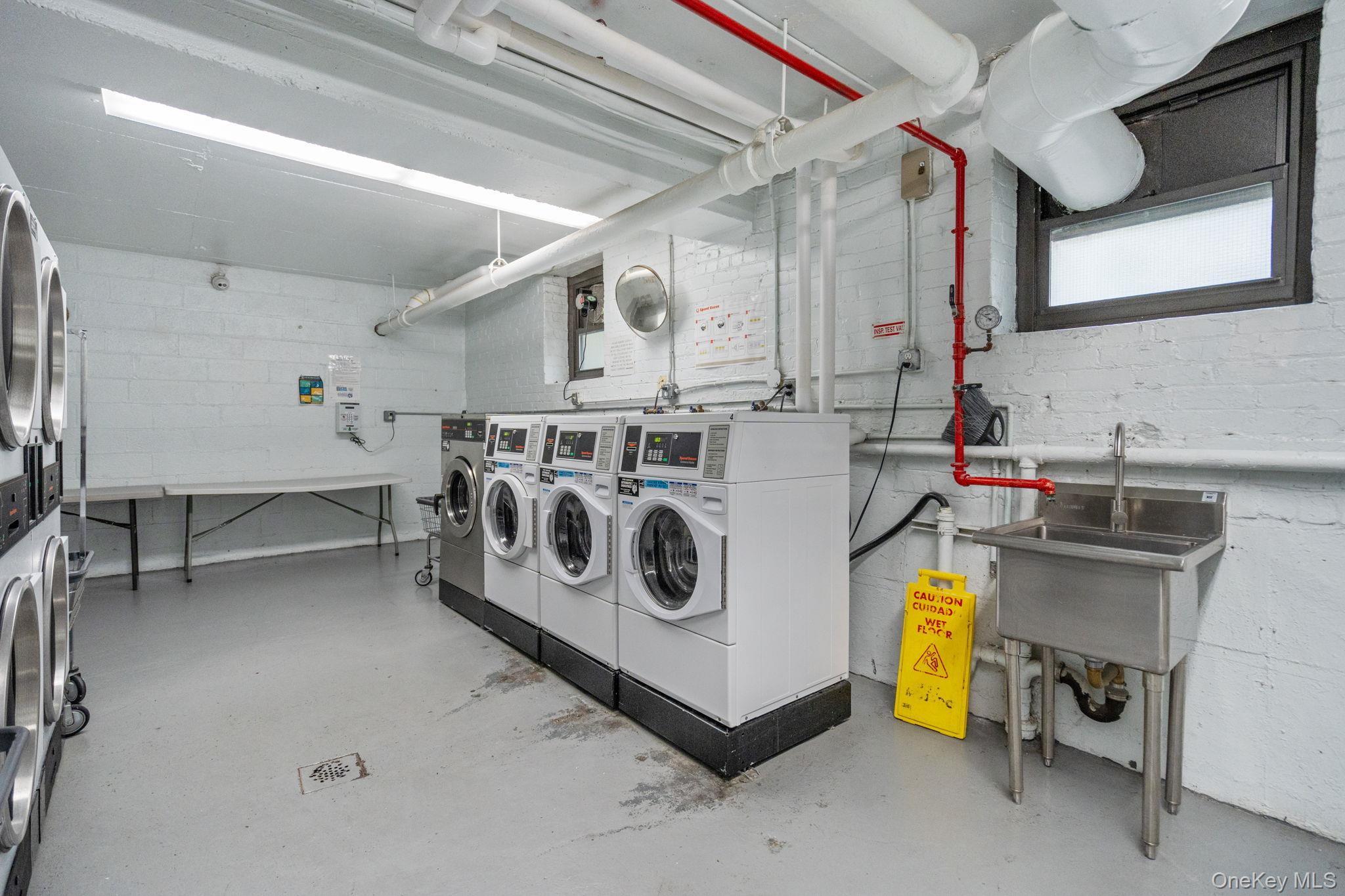 32-40 89th Street, Unit C409 Queens, NY 11369 - Photo 26 of 32 a utility room with dryer and washer
