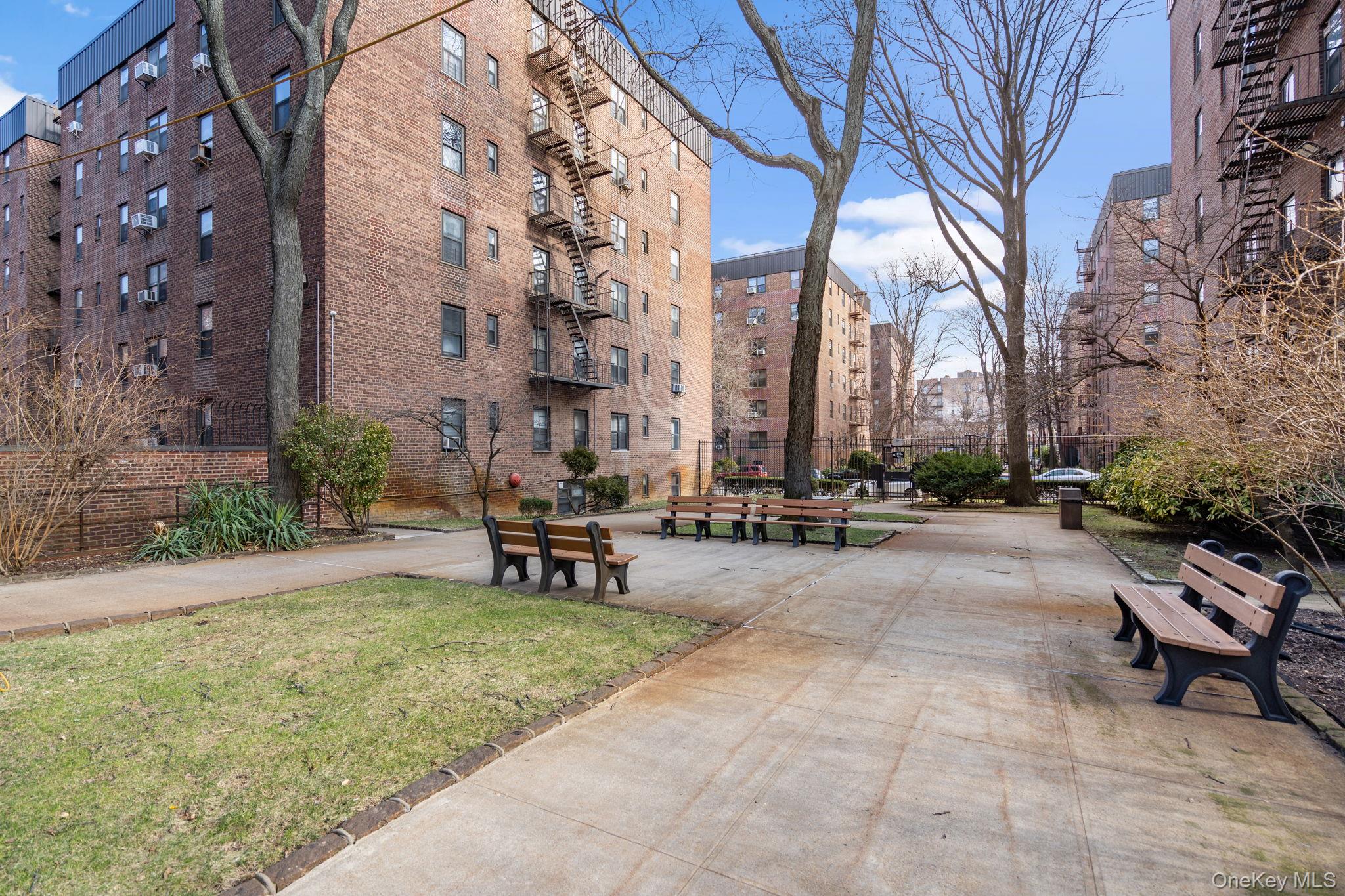 32-40 89th Street, Unit C409 Queens, NY 11369 - Photo 29 of 32 a view of a building with backyard and sitting area