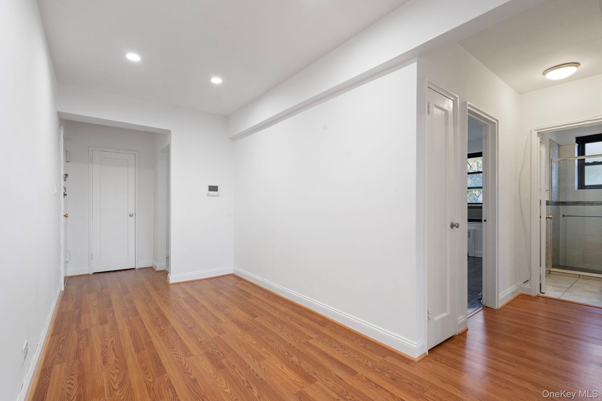 32-40 89th Street, Unit C409 Queens, NY 11369 - Photo 7 of 32 a view of a hallway with wooden floor