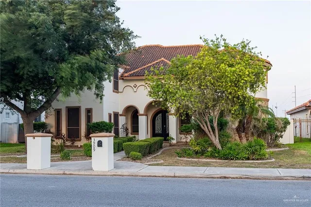 a front view of a house with a garden and plants