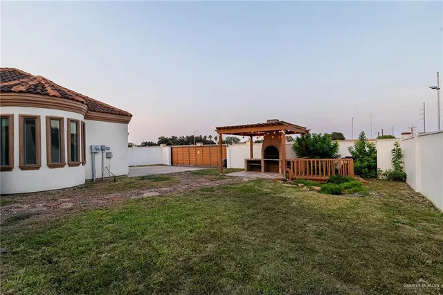 a view of a house with a big yard and large trees