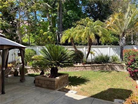 9 Nutcracker Lane Aliso Viejo, CA 92656 - Photo 5 of 15 a palm tree sitting in a yard next to a house