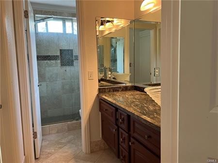 9 Nutcracker Lane Aliso Viejo, CA 92656 - Photo 7 of 15 a bathroom with a granite countertop sink and a mirror