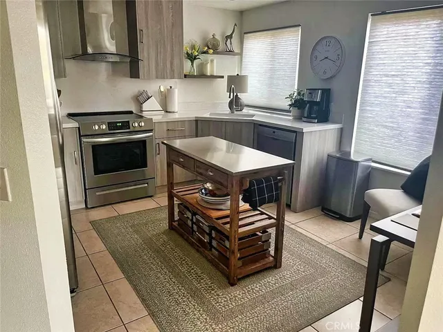 a kitchen with a stove a sink and a refrigerator