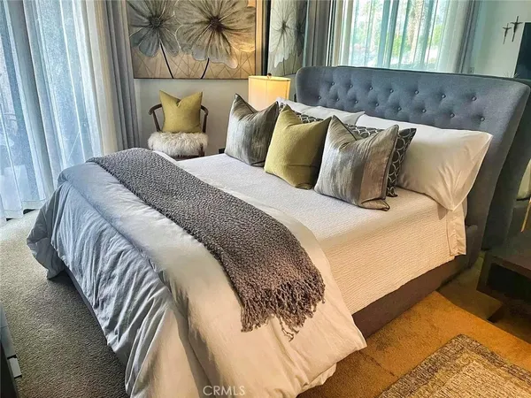 a bed sitting in a bedroom next to a window