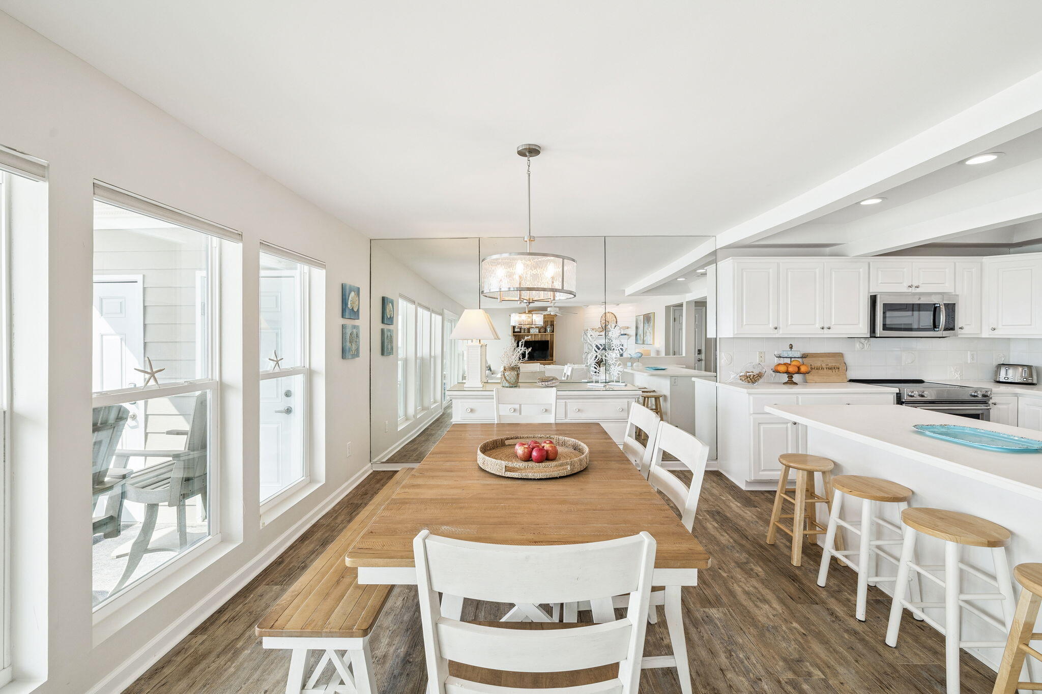 142 Beachside Drive, Unit 10 Santa Rosa Beach, FL 32459 - Photo 11 of 42 a kitchen with stainless steel appliances granite countertop a stove a sink dishwasher and white cabinets with wooden floor