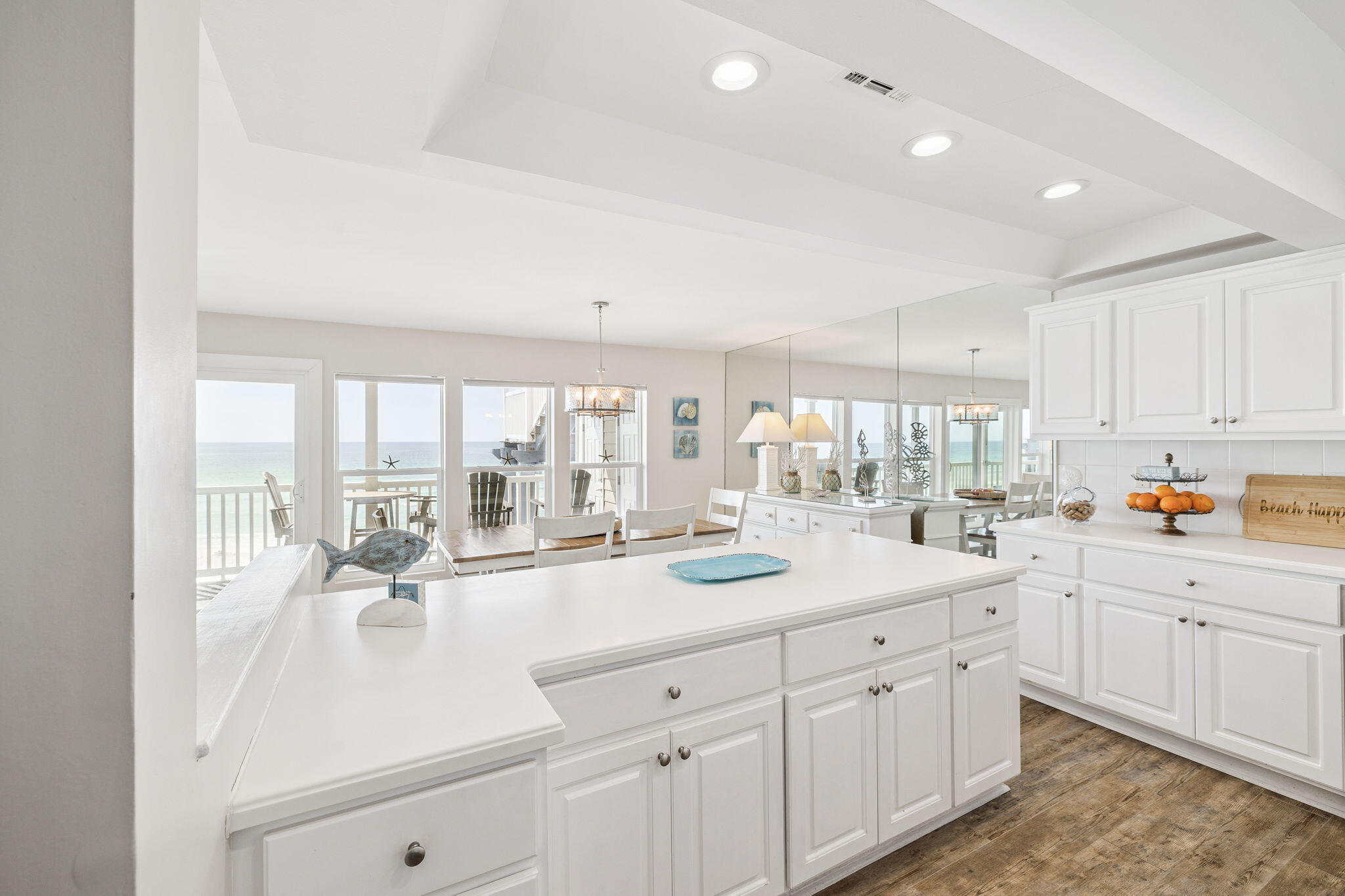 142 Beachside Drive, Unit 10 Santa Rosa Beach, FL 32459 - Photo 18 of 42 a large white kitchen with a lot of counter space and a wooden floor
