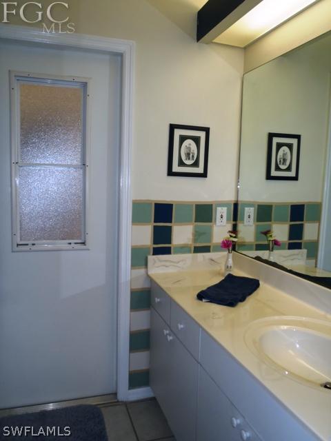 17549 Allentown Road Fort Myers, FL 33967 - Photo 11 of 14 a room with a sink and a stove with wooden floor