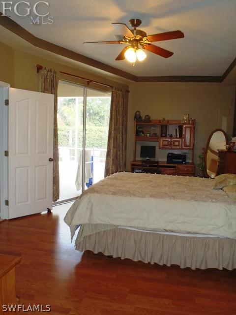 17549 Allentown Road Fort Myers, FL 33967 - Photo 6 of 14 a bedroom with a large bed and a chandelier
