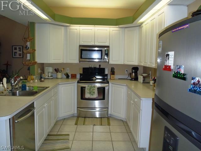 17549 Allentown Road Fort Myers, FL 33967 - Photo 8 of 14 a kitchen with a sink a stove and cabinets