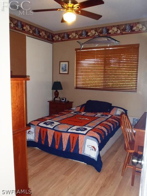 17549 Allentown Road Fort Myers, FL 33967 - Photo 10 of 14 a bedroom with a bed and wooden floor