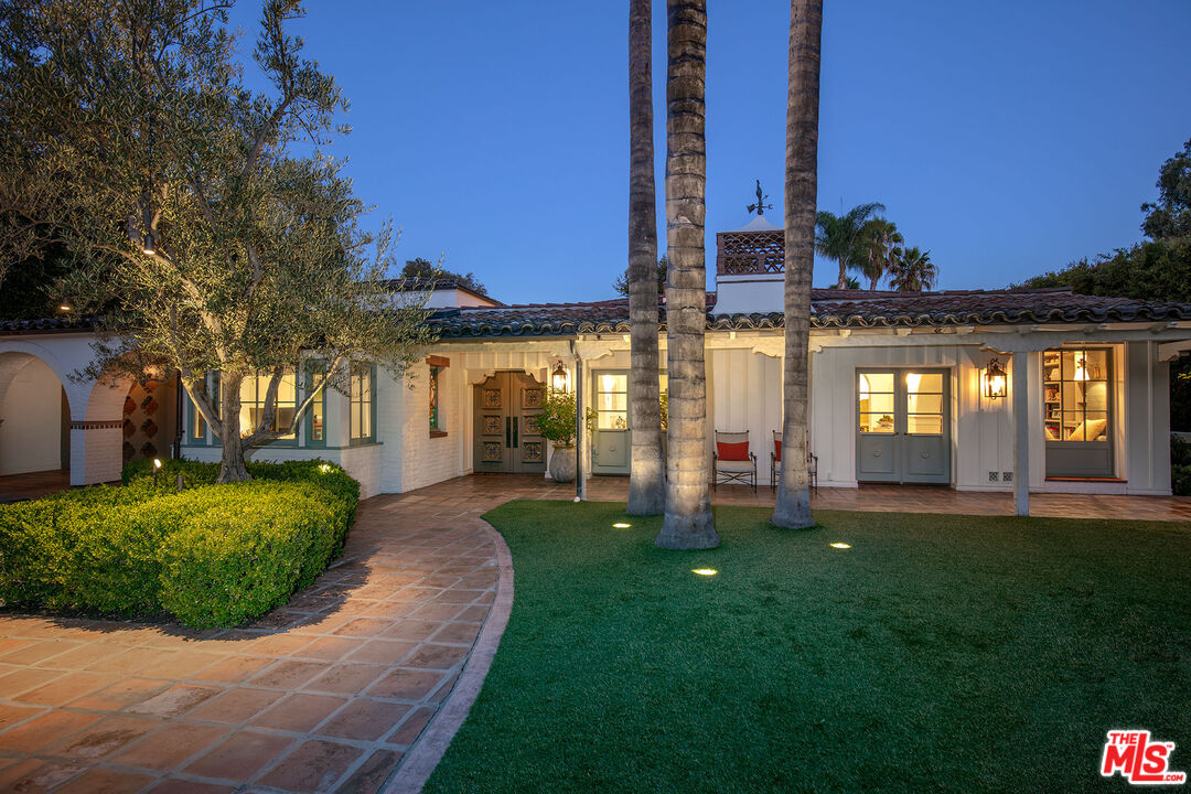318 North Rockingham Avenue Los Angeles, CA 90049 - Photo 1 of 1 a front view of a house with a yard and trees