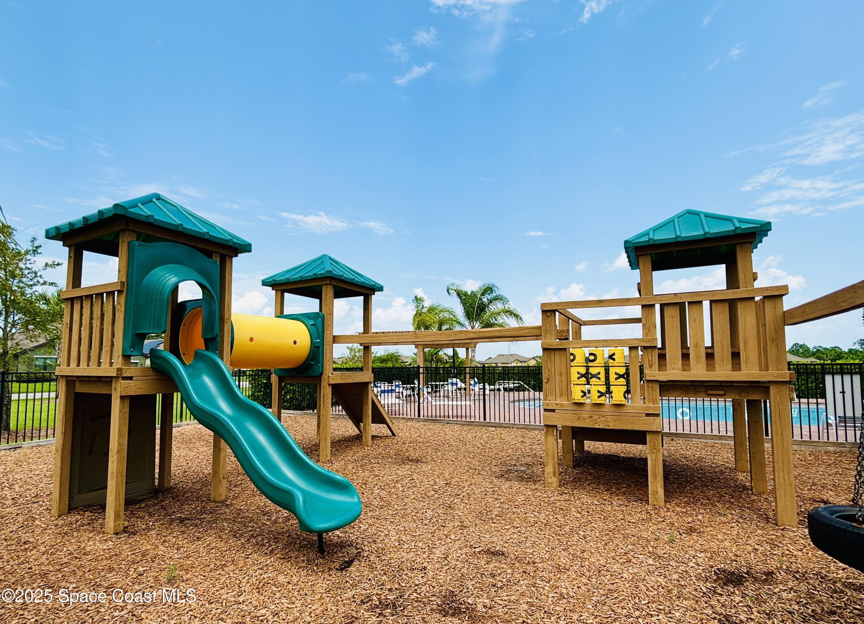 841 Old Country Rd S East Palm Bay, FL 32909 - Photo 11 of 16 a backyard of a house with barbeque oven table and chairs