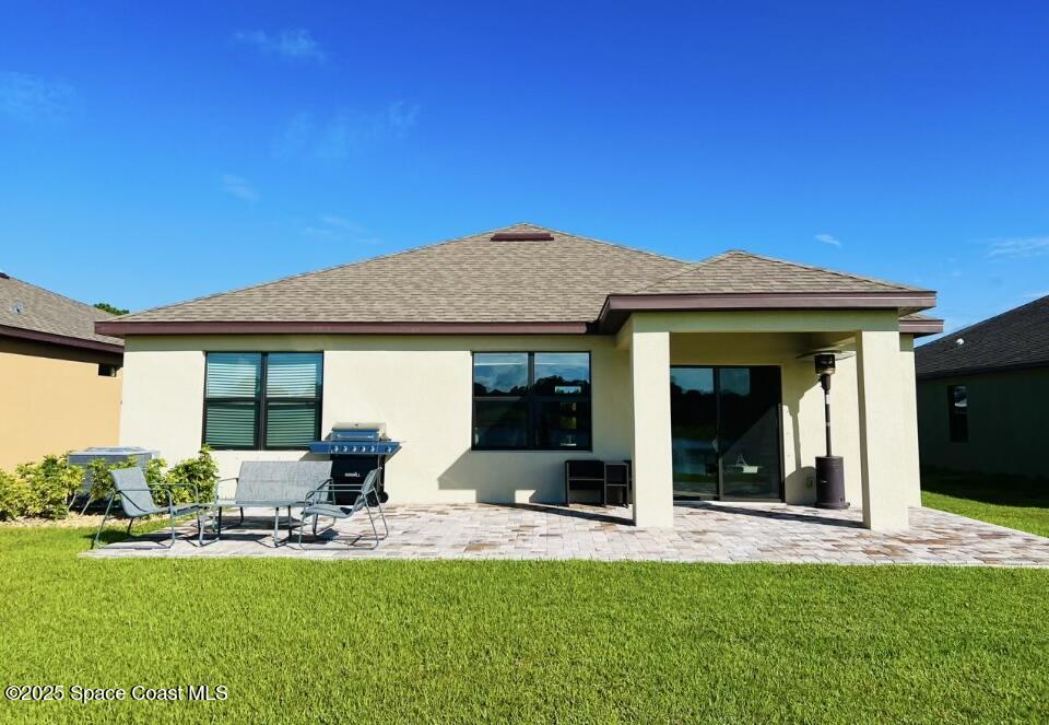 841 Old Country Rd S East Palm Bay, FL 32909 - Photo 13 of 16 a front view of a house with a garden and patio
