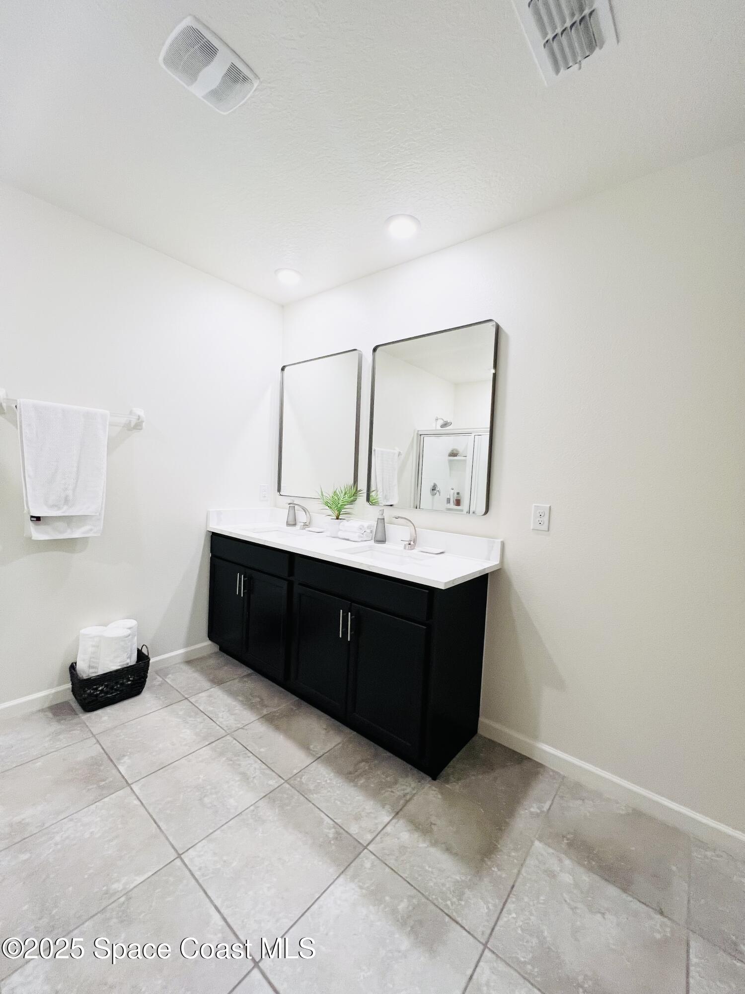 841 Old Country Rd S East Palm Bay, FL 32909 - Photo 8 of 16 a bathroom with a sink vanity and a mirror