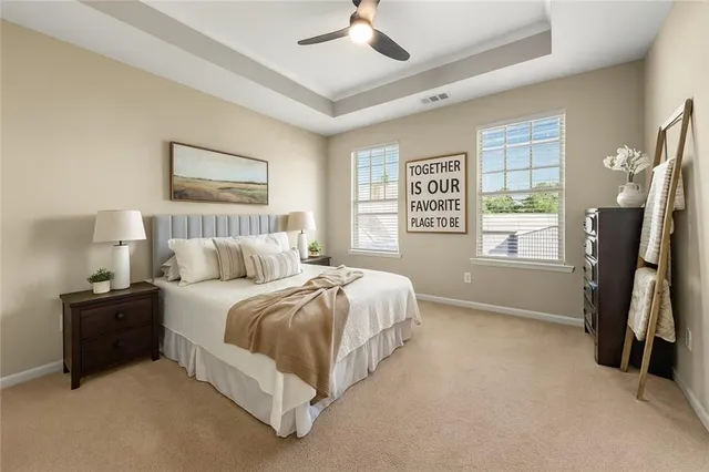 a spacious bedroom with a bed and a chandelier