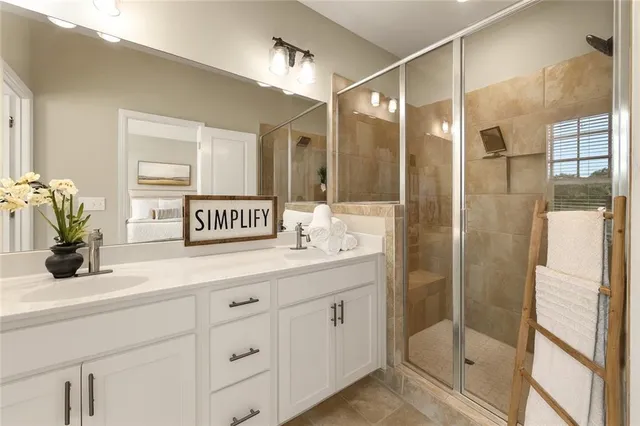 a bathroom with a shower sink and a mirror