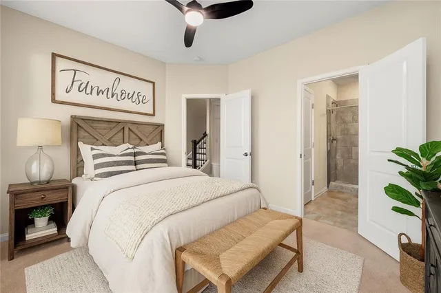 a bedroom with a bed and a potted plant