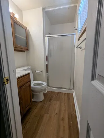 a bathroom with a toilet and a shower