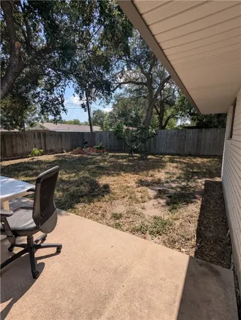 a view of a backyard with chairs