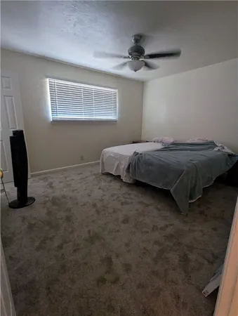 a bed sitting in a bedroom next to a window