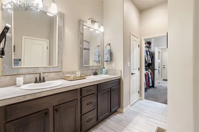 a en suite bathroom with a double vanity sink double and a mirror