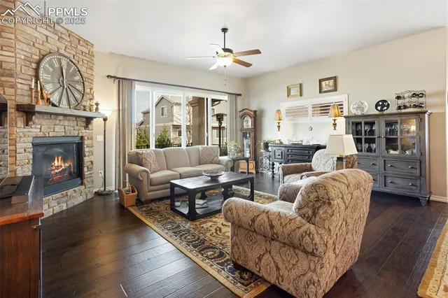 a living room with furniture large window and fireplace