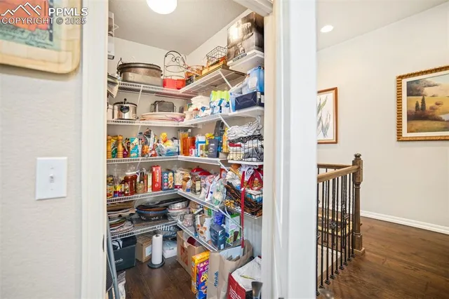 a view of walk in closet with clothes