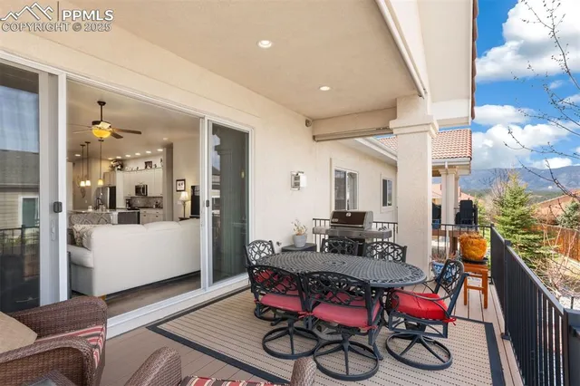 a backyard of a house with table and chairs