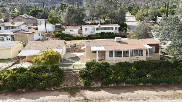 a view of a house with yard and sitting area
