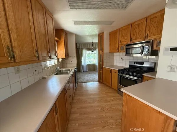 a kitchen with stainless steel appliances a stove sink and cabinets