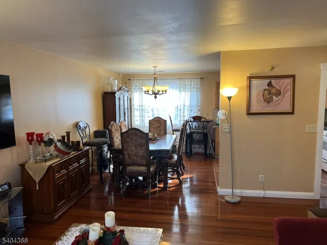 a view of a dining room with furniture and chandelier