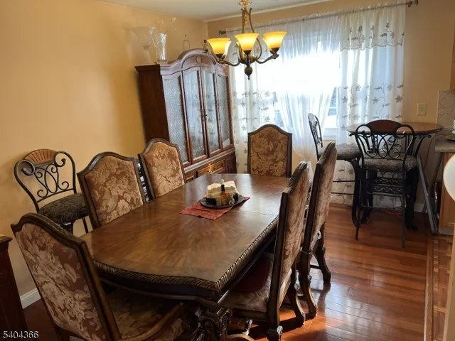 a view of a dining room with furniture and chandelier