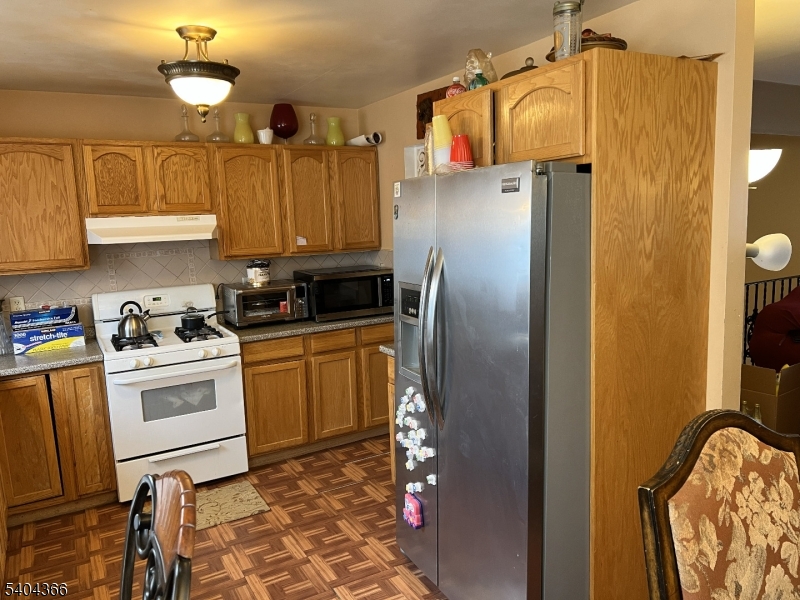 415 Wheatsheaf Road Roselle, NJ 07203 - Photo 18 of 30 a kitchen with stainless steel appliances granite countertop a refrigerator a stove and a sink