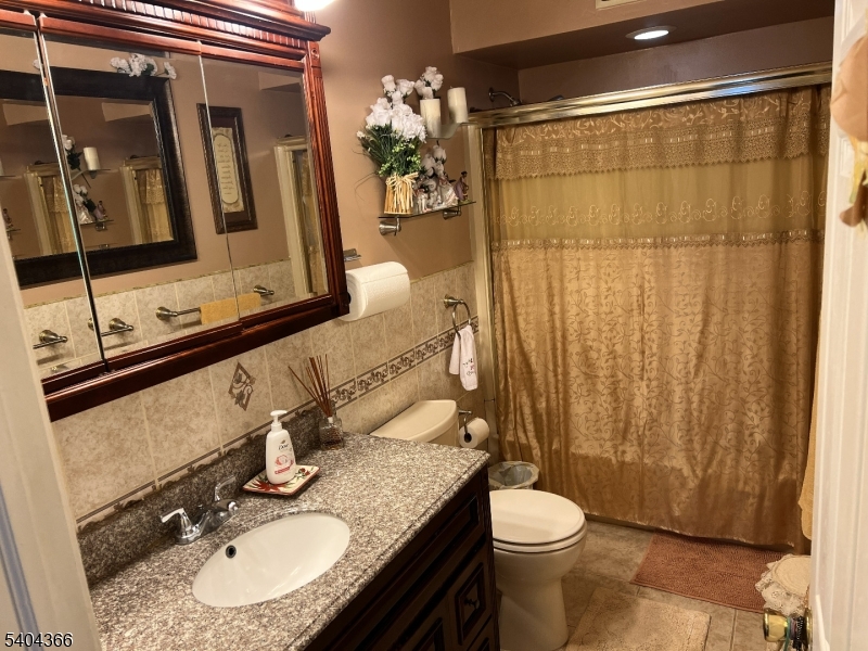 415 Wheatsheaf Road Roselle, NJ 07203 - Photo 20 of 30 a bathroom with a granite countertop sink toilet and shower