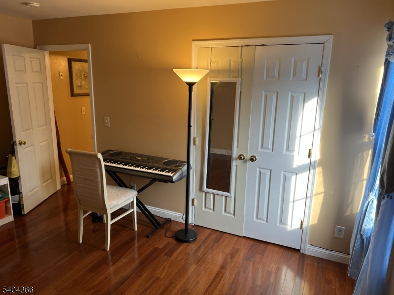 415 Wheatsheaf Road Roselle, NJ 07203 - Photo 22 of 30 a room with wooden floor and a window