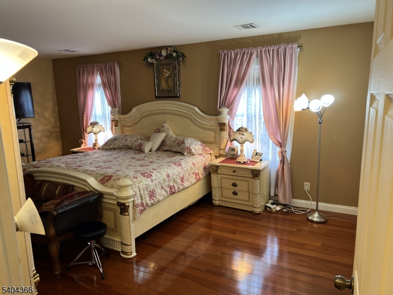 415 Wheatsheaf Road Roselle, NJ 07203 - Photo 23 of 30 a bedroom with a bed and large windows