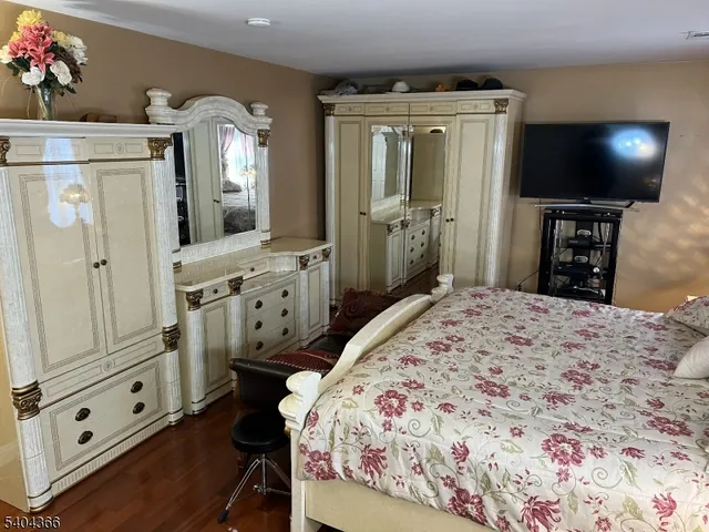 a bedroom with a bed and a dresser