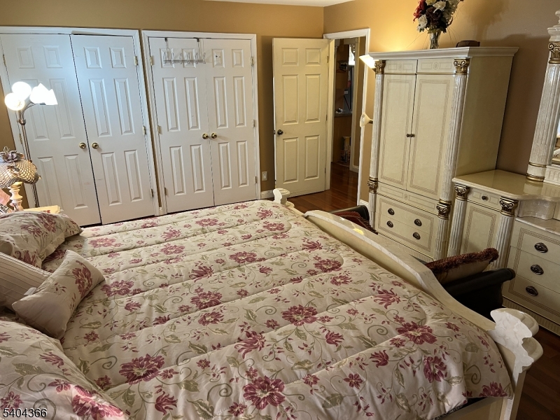 415 Wheatsheaf Road Roselle, NJ 07203 - Photo 26 of 30 a bedroom with a bed a flat tv screen and a dresser