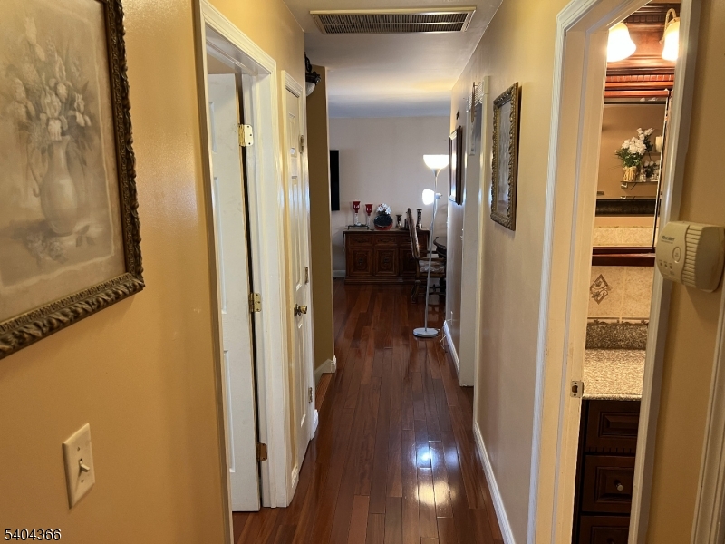 415 Wheatsheaf Road Roselle, NJ 07203 - Photo 27 of 30 a view of a hallway with wooden floor and a bathroom