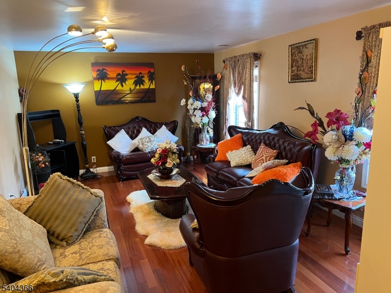415 Wheatsheaf Road Roselle, NJ 07203 - Photo 4 of 30 a living room with furniture and a chandelier
