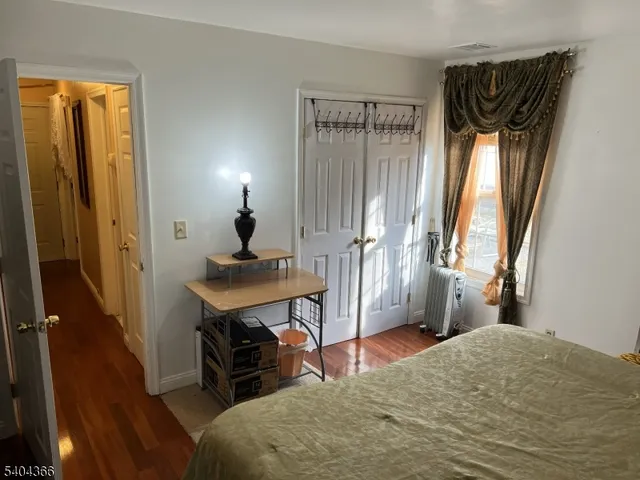 a bedroom with a bed and a mirror