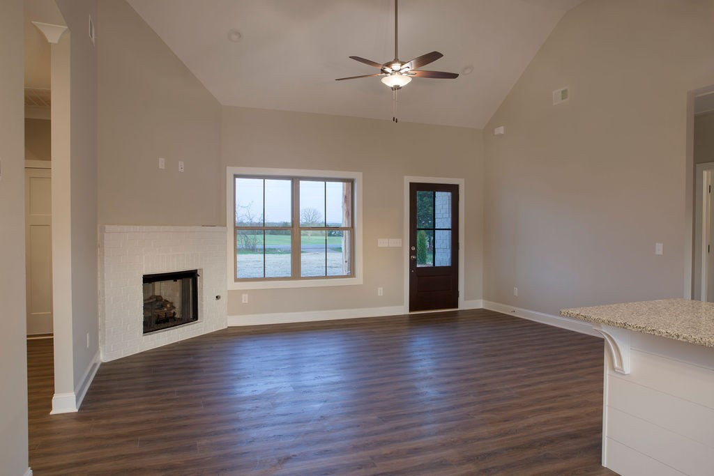 2348 Allen Ferry Road Smithville, TN 37166 - Photo 11 of 23 an empty room with wooden floor fireplace and windows