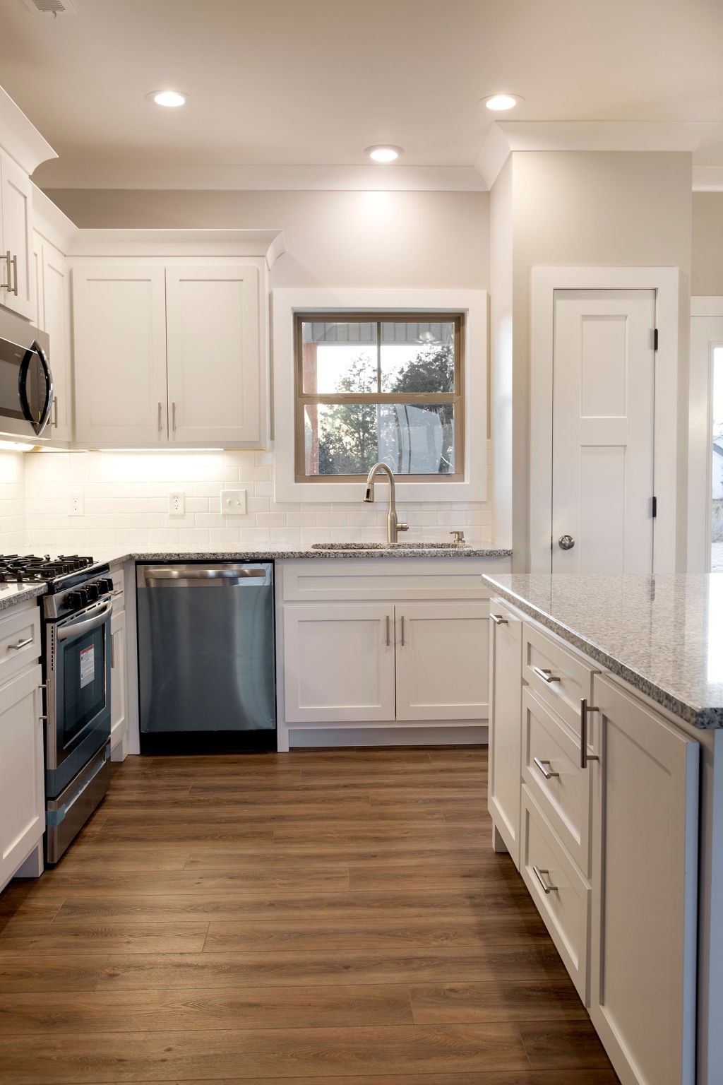 2348 Allen Ferry Road Smithville, TN 37166 - Photo 8 of 23 a large kitchen with stainless steel appliances granite countertop a stove a sink and white cabinets