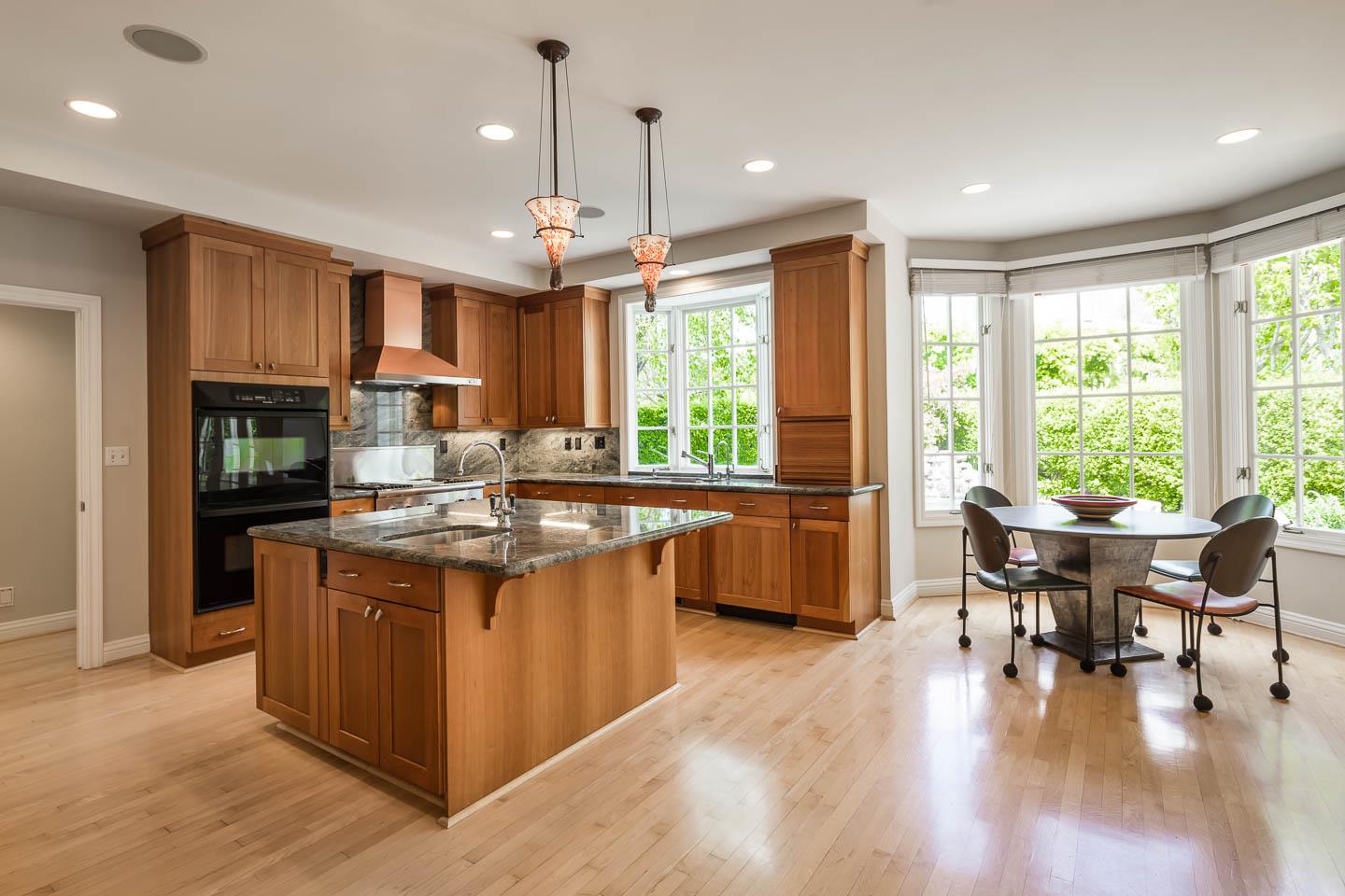 290 Gloria Circle Menlo Park, CA 94025 - Photo 19 of 41 a kitchen with stainless steel appliances granite countertop a stove top oven a sink dishwasher a dining table and chairs with wooden floor