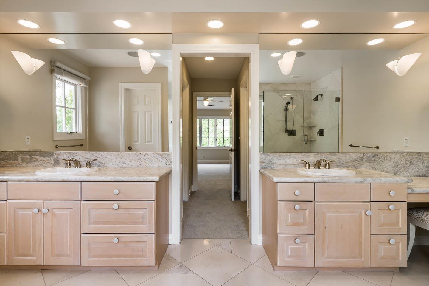 290 Gloria Circle Menlo Park, CA 94025 - Photo 33 of 41 a bathroom with a granite countertop sink a large mirror and a shower