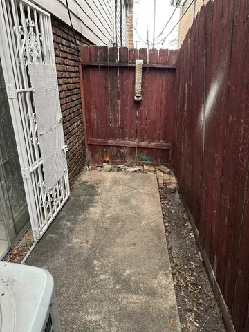 a view of a patio with a table and chairs under an umbrella